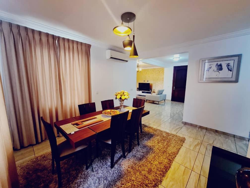 a dining room with a wooden table and chairs at Bertha's Court D-Plus Apartments in Greenhill