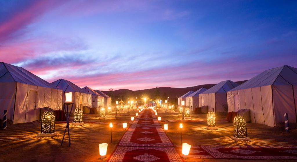 a group of tents with candles in the middle at Ammar Luxury Camp in Merzouga