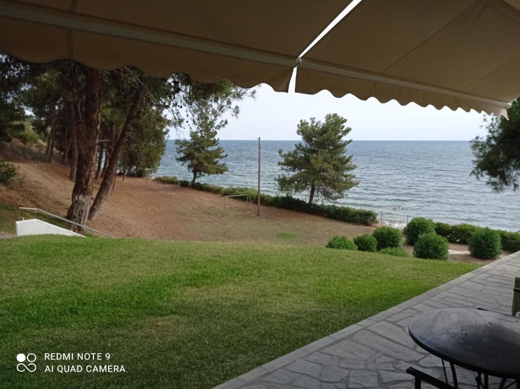 a view of the ocean from the porch of a house at Sunset Apartment in Epanomi