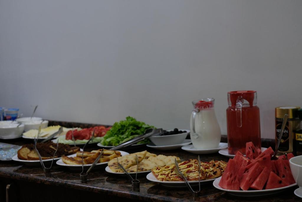 a buffet with plates of food on a table at Eiffel Hotel in Batumi