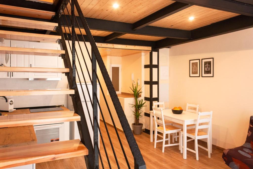 a kitchen and dining room with a staircase and a table at Marittimo Apartments in Valencia
