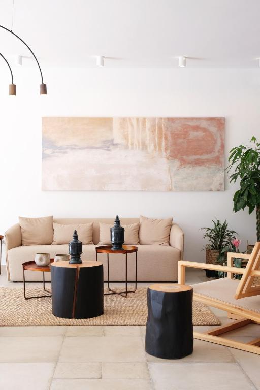 a living room with a couch and tables at Margo Beach Hotel in Gythio