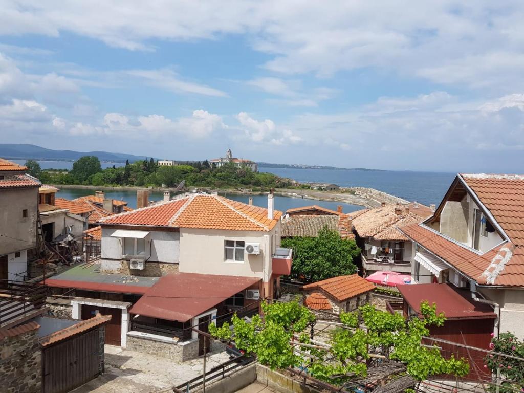 a view of a town with houses and the ocean at Guest House Antique in Sozopol
