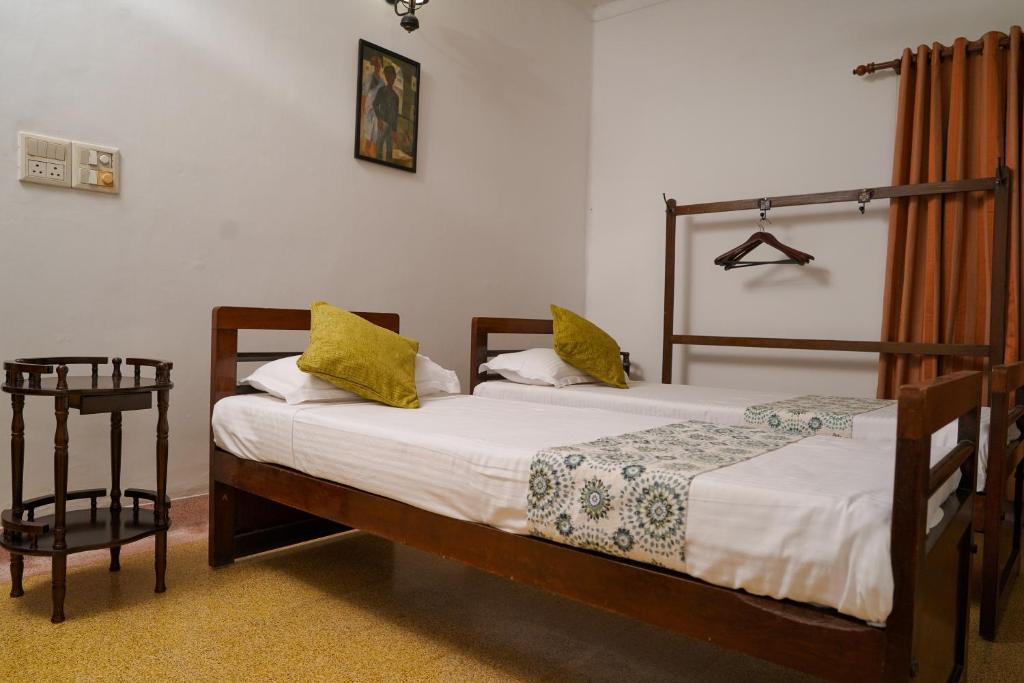 Posteľ alebo postele v izbe v ubytovaní Govindamangalam Homestay