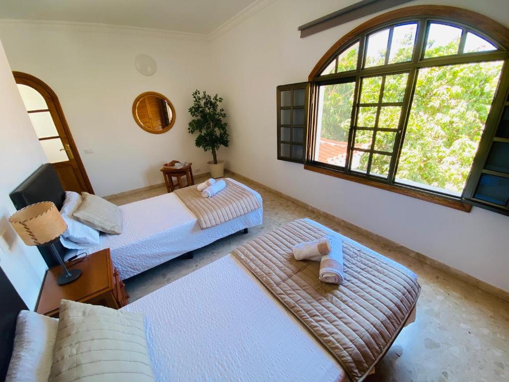 A bed or beds in a room at Villa Carolina with private pool