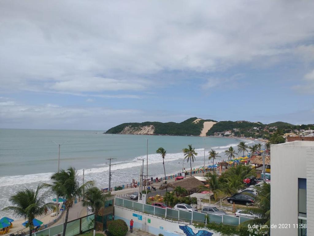 a view of a beach with palm trees and the ocean at PONTA NEGRA BEACH - Natal in Natal
