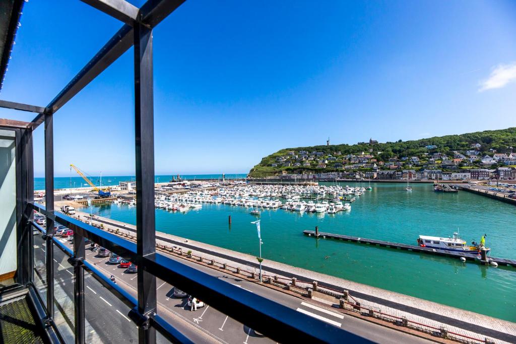 a view of a marina with boats in the water at Hotel Le Grand Pavois in Fécamp