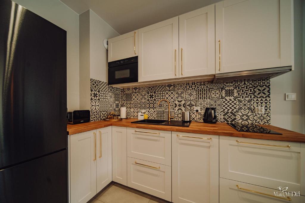 Kuchyňa alebo kuchynka v ubytovaní Apartament Silence Karpatia Resort Nefryt
