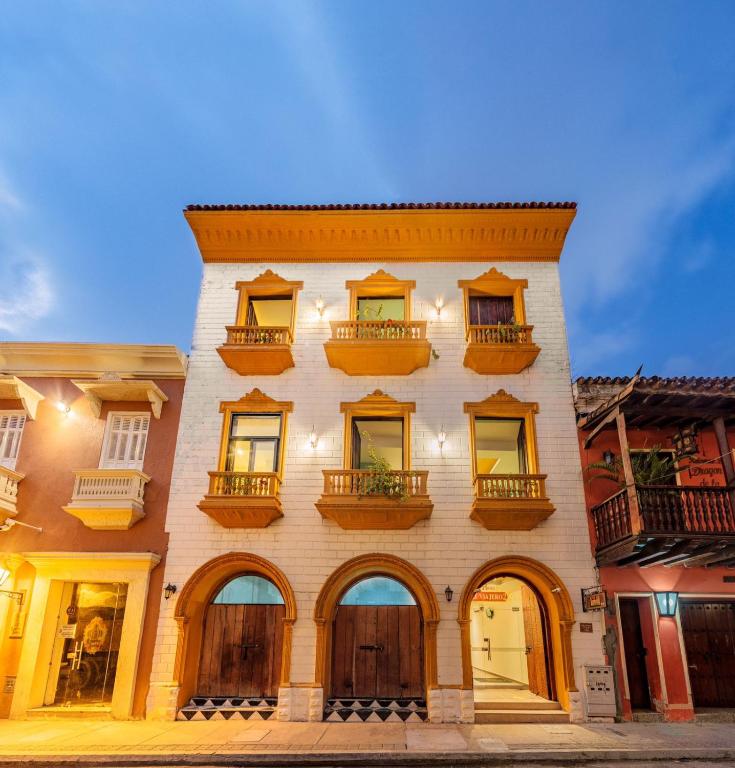 a tall building with windows and balconies on it at Hotel El Viajero #2 in Cartagena de Indias