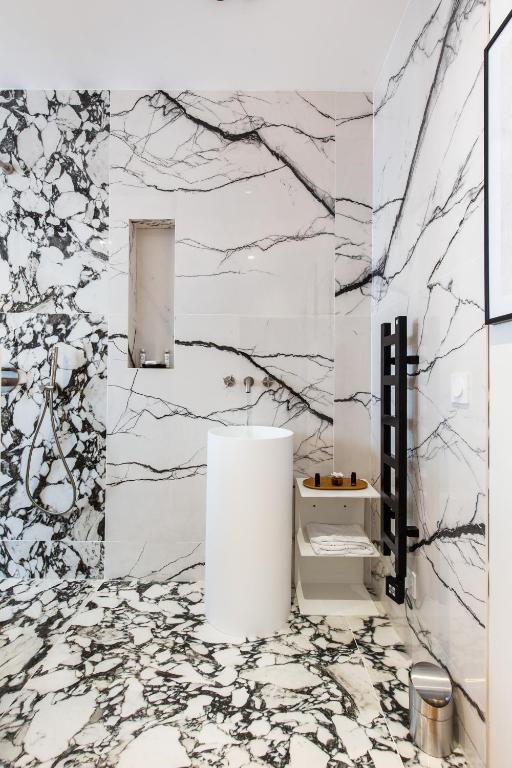 a bathroom with white marble walls and a sink at CMG BASTILLE &#47; GARE DE LYON 2 in Paris