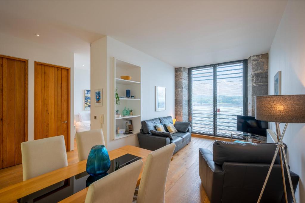 a living room with a couch and a table at Royal William Yard Apartments in Plymouth
