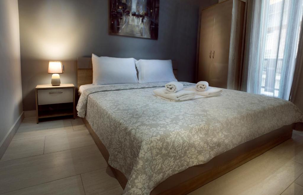 a bedroom with a bed with two towels on it at Haus Viktoria 3 in Limenas