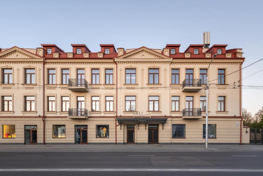 a large building on the corner of a street at CALVARY Hotel & Restaurant Vilnius in Vilnius