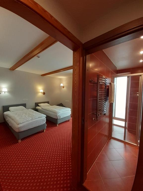 a hotel room with two beds and a bathroom at Plytu 9 apartment in Palanga