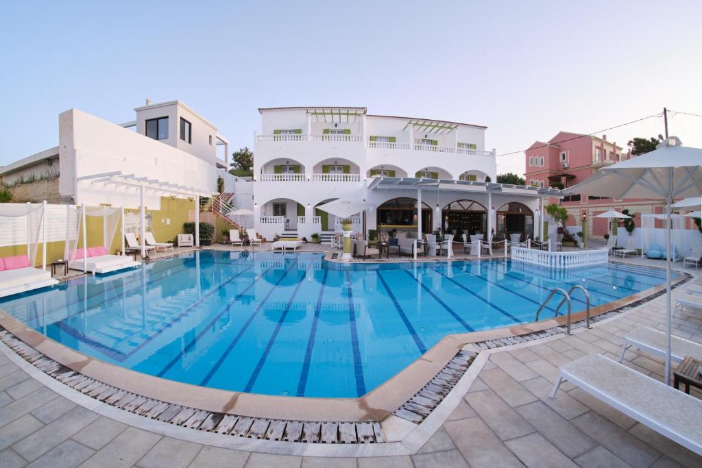 a large swimming pool in front of a building at Fedra Mare in Agios Stefanos