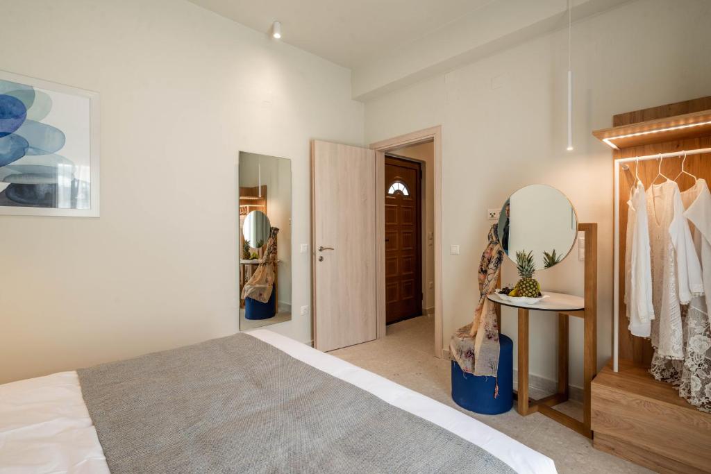a bedroom with a bed and a dressing room at Syvota Gardens in Syvota