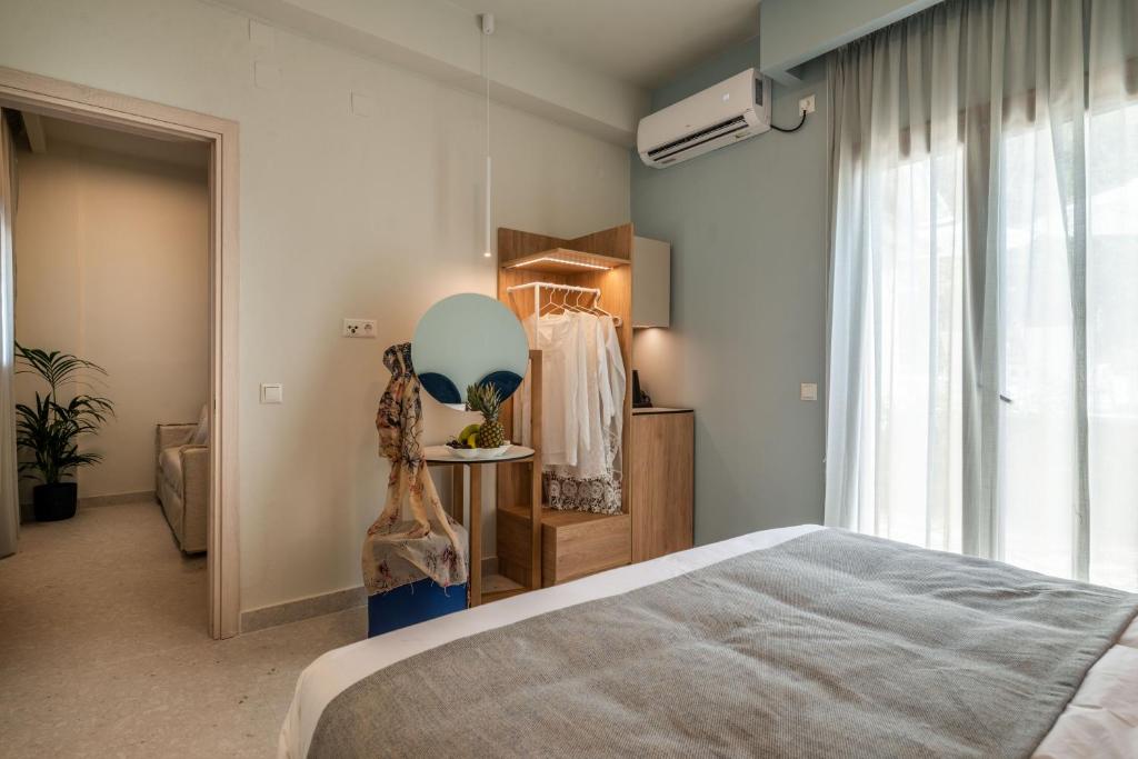 a bedroom with a bed and a mirror and a window at Syvota Gardens in Syvota