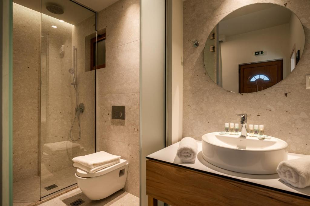 a bathroom with a sink and a shower and a toilet at Syvota Gardens in Syvota
