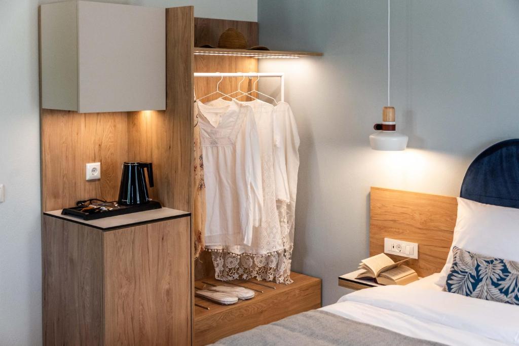 a bedroom with a bed and a closet with a dresser at Syvota Gardens in Syvota
