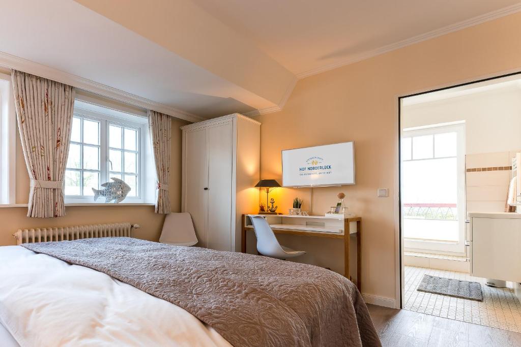 Postel nebo postele na pokoji v ubytování Hof Norderlück - Das Ostseehotel unter Reet