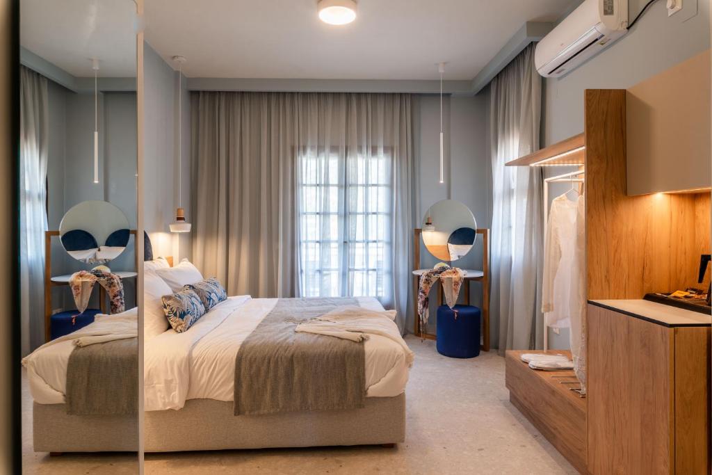 a bedroom with a bed and a large window at Syvota Gardens in Syvota