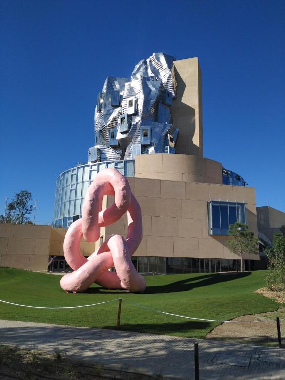a large pink sculpture in front of a building at Appartement Arles Centre Historique in Arles
