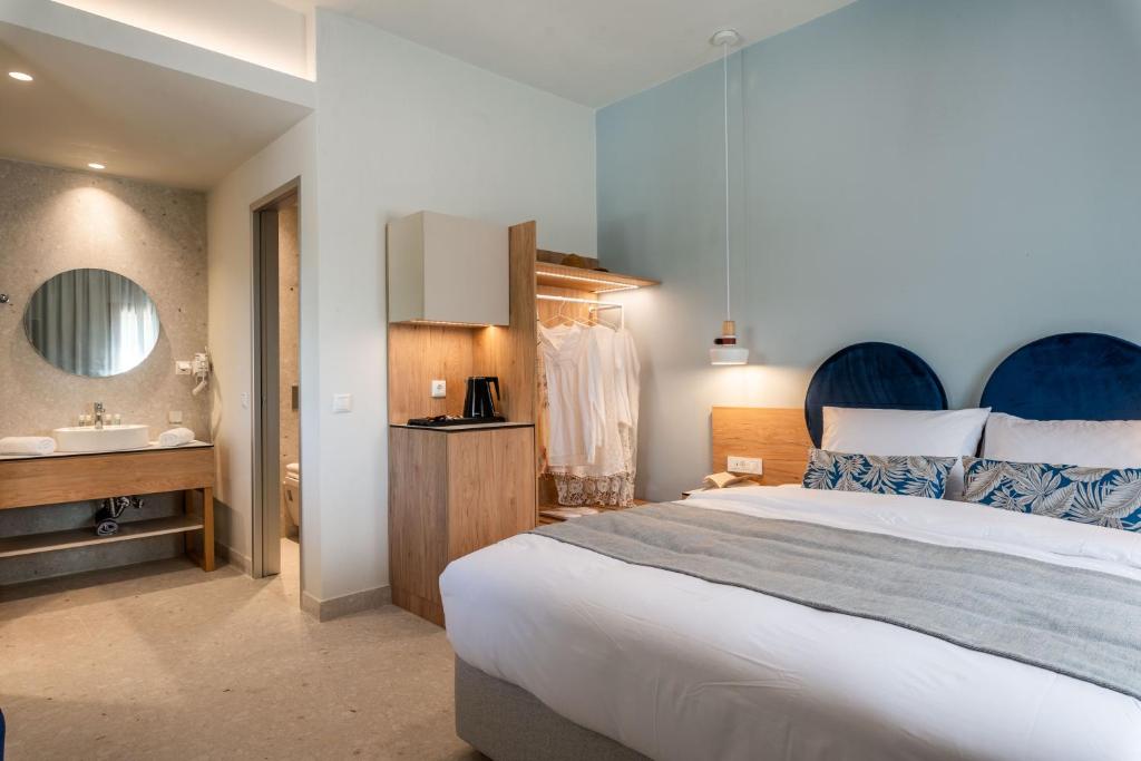 a bedroom with a large bed and a sink at Syvota Gardens in Syvota