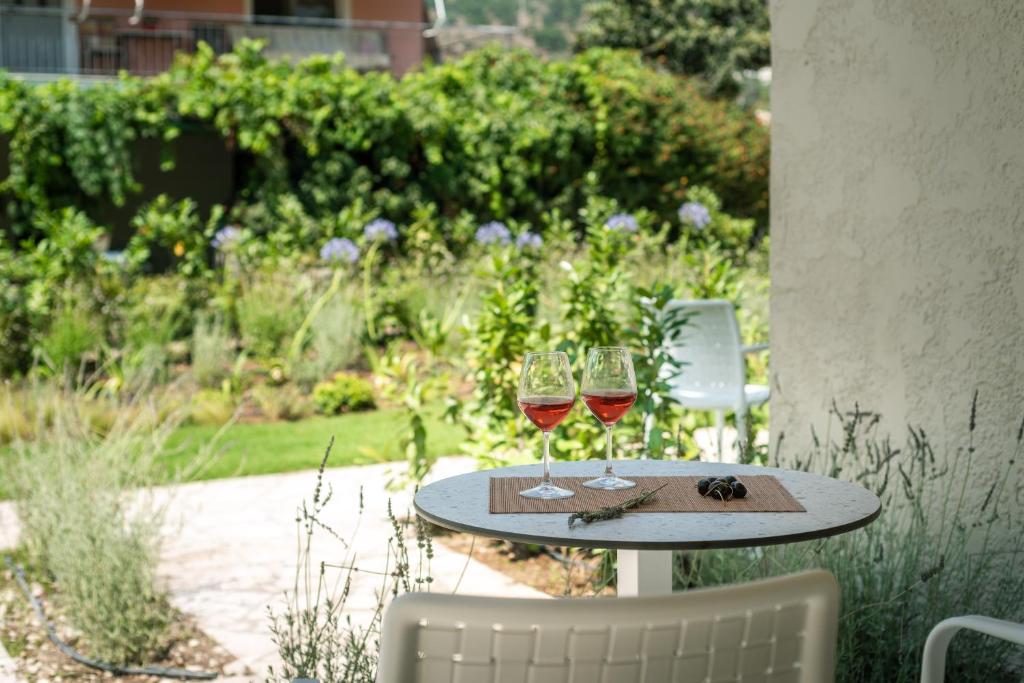 two glasses of wine sitting on a table at Syvota Gardens in Syvota