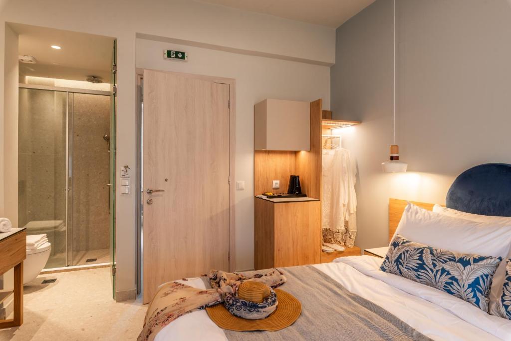 a bedroom with a bed with a hat on it at Syvota Gardens in Syvota