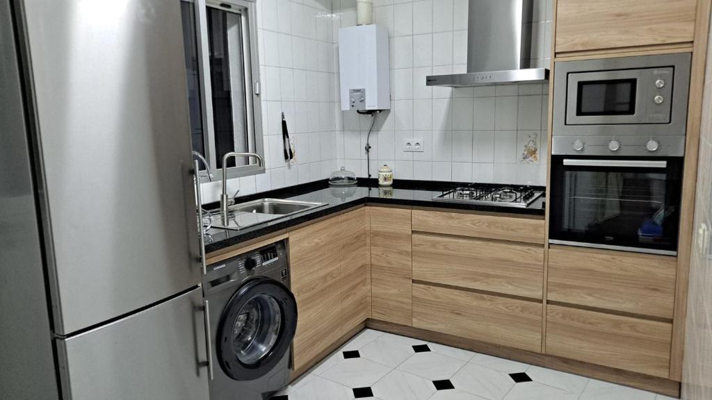 a kitchen with a washing machine and a sink at Casa El Villa in Zahara de la Sierra