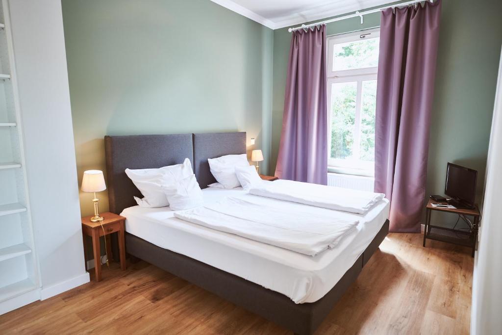 Postel nebo postele na pokoji v ubytování Gutshotel Baron Knyphausen