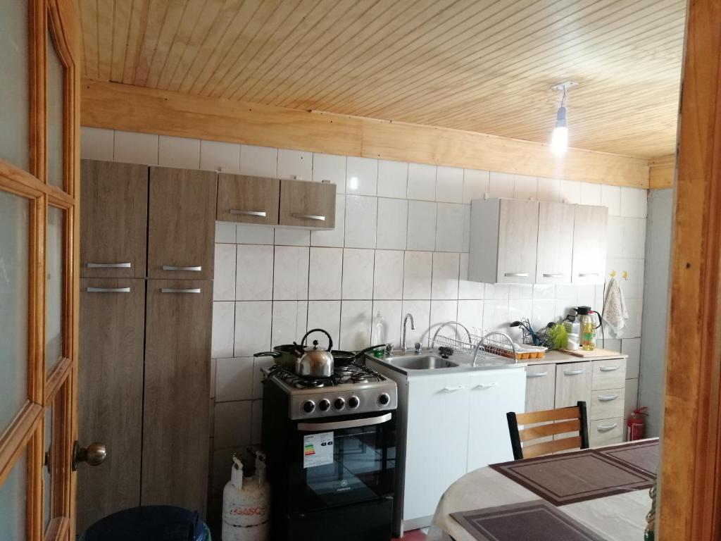 a small kitchen with a stove and a sink at La Casa Blanca in San Pedro de Atacama