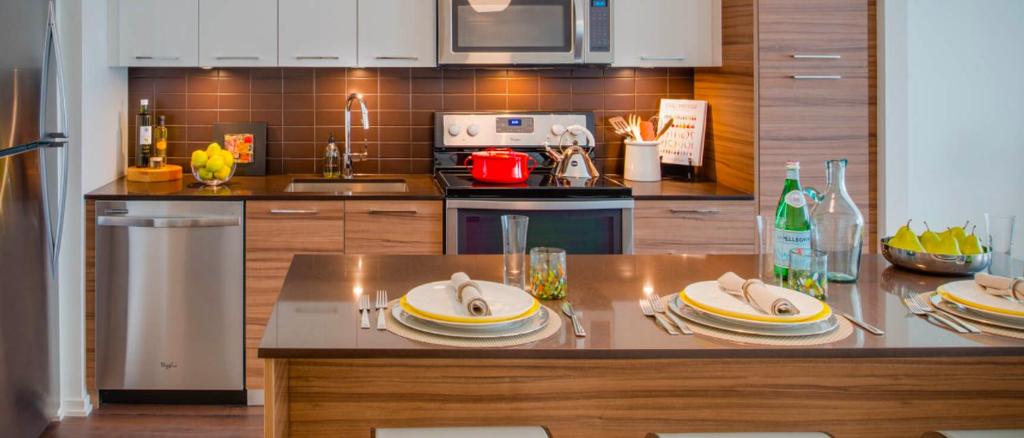 a kitchen with a counter with plates on it at National at Tysons Center in Howard