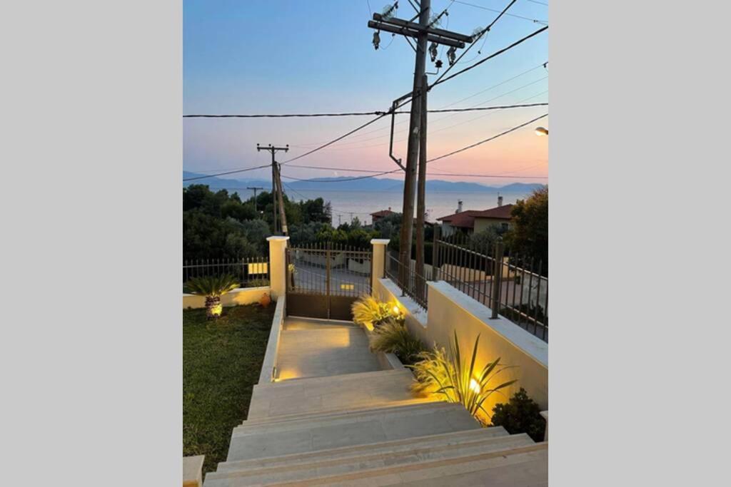 a set of stairs leading up to a house with the sunset at CASA LOUKAS in Nerotriviá