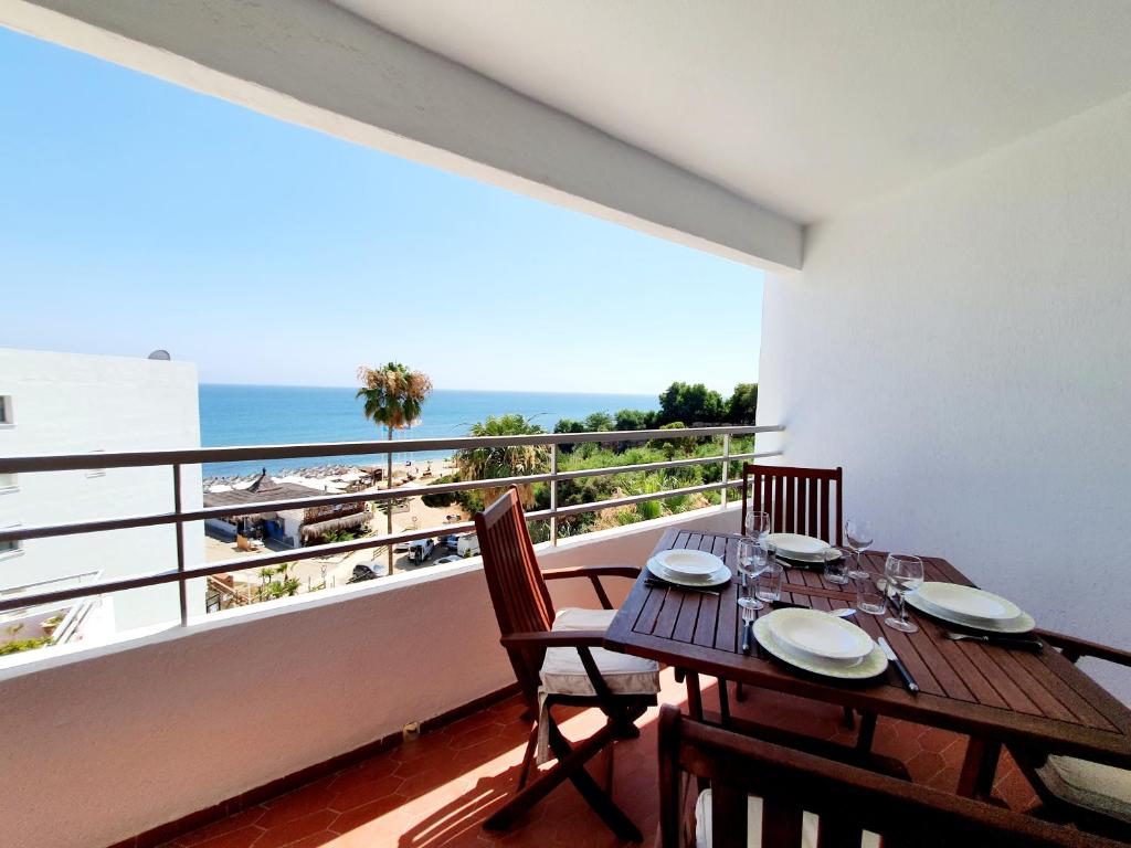 a dining room with a table and a view of the beach at Marbellamar Seaviews in Cabopino