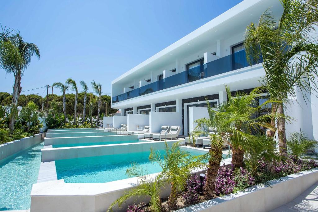 an exterior view of a house with a swimming pool at Vanik Suites in Kallithea Rhodes