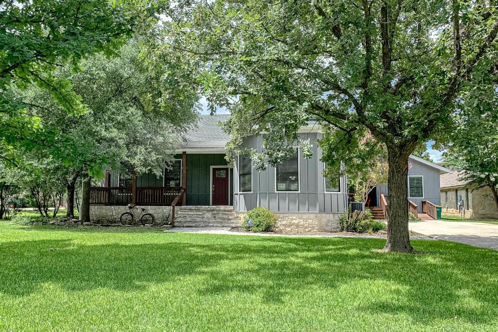 a house with a green yard with a tree at Riverside Sanctuary in Boerne