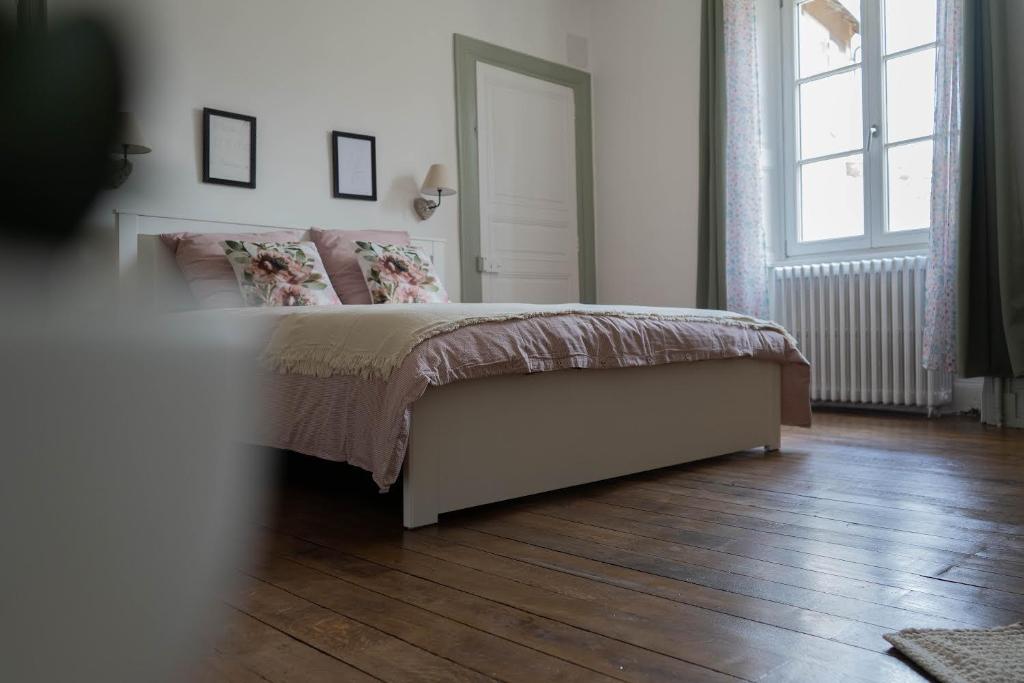 1 dormitorio con 1 cama y suelo de madera en un dimanche chez Julie chambre Léontine en Parthenay