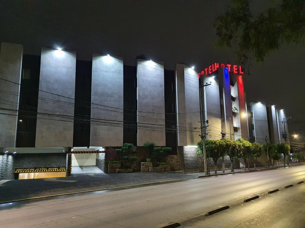 un edificio con un letrero iluminado por la noche en Hotel Paraiso, en Ciudad de México