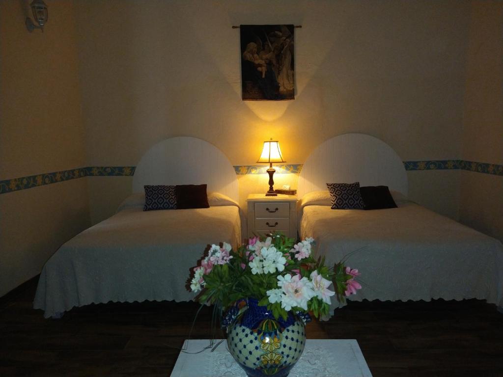 Postel nebo postele na pokoji v ubytování Hotel Spa Hacienda Real la Nogalera