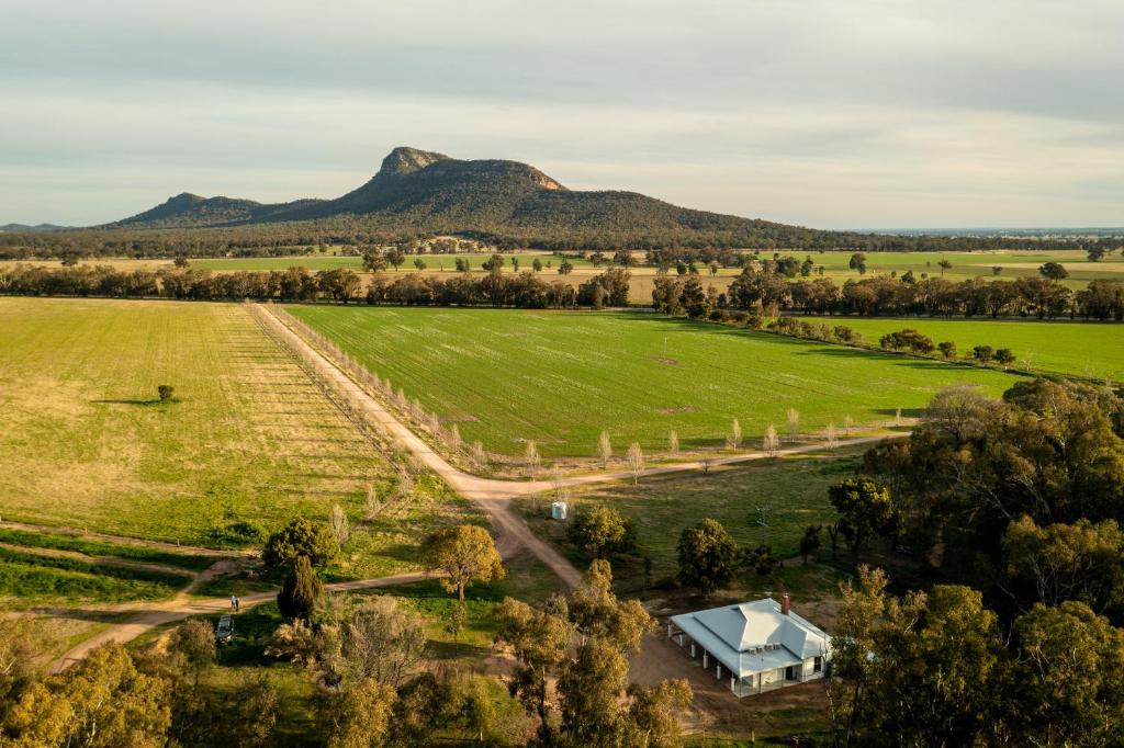 an aerial view of a farm with mountains in the background at Avalon Farm Stay in The Rock