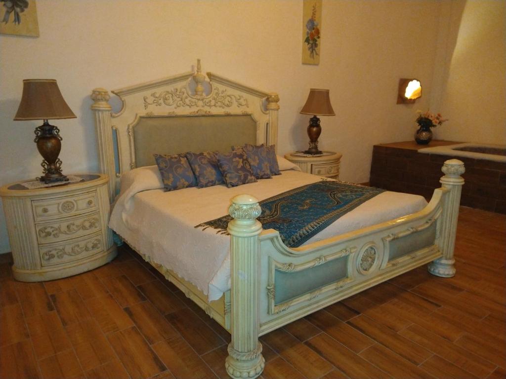 Postel nebo postele na pokoji v ubytování Hotel Spa Hacienda Real la Nogalera