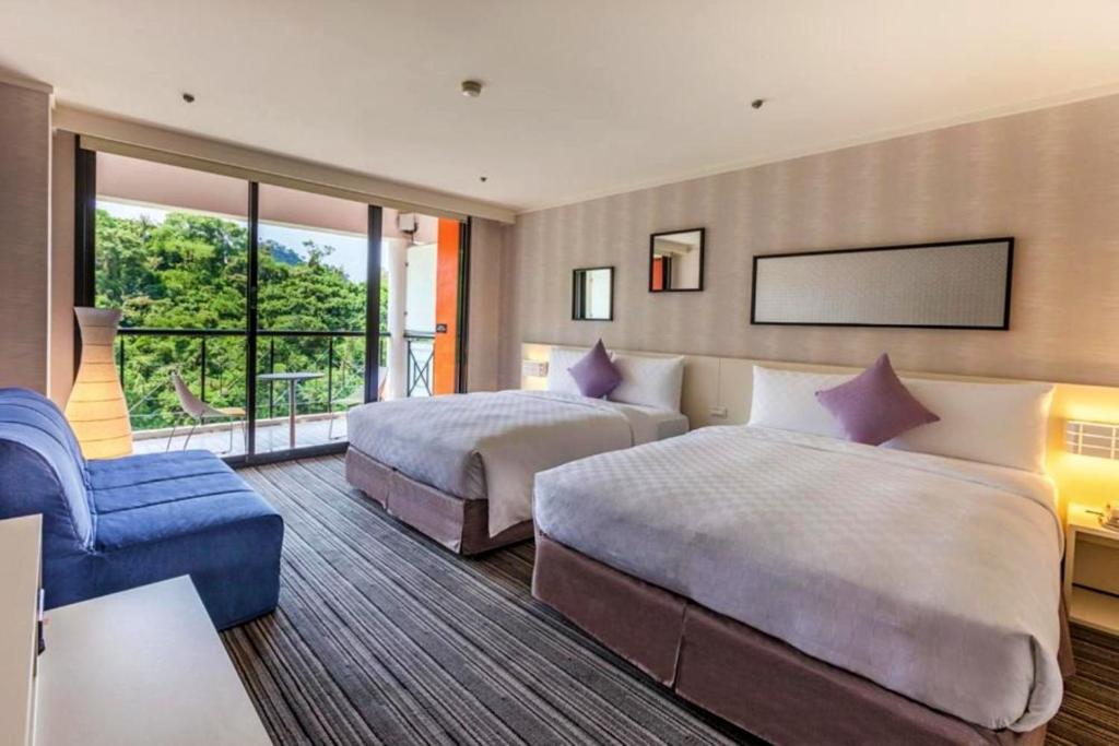 Postel nebo postele na pokoji v ubytování 凱撒趣淘漫旅-台南 HOTEL CHAM CHAM Tainan