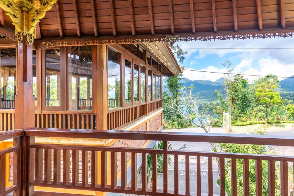 a building with a balcony with a view of the mountains at The Garuda Villa and Restaurant in Bedugul