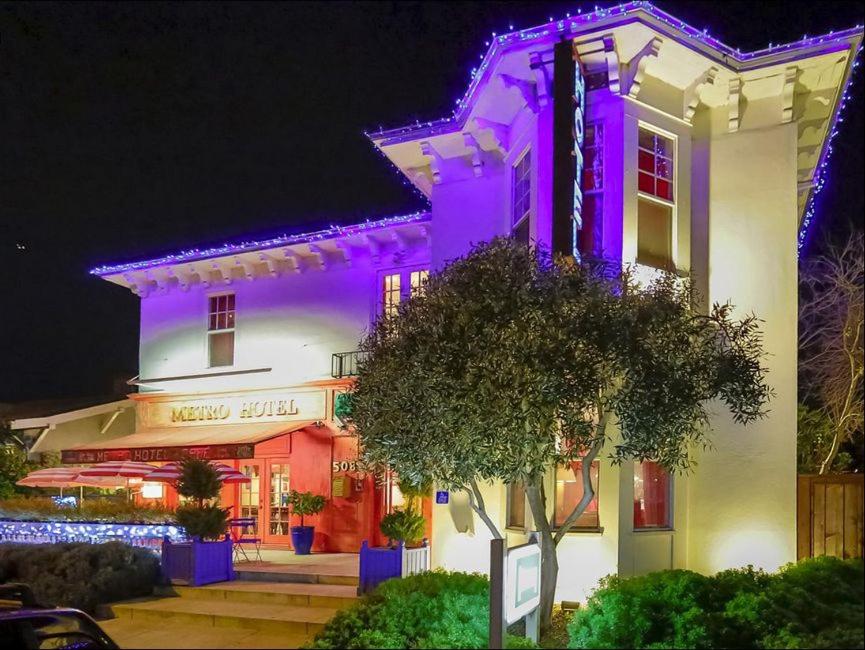 a white building with purple lights on it at metro hotel in Petaluma