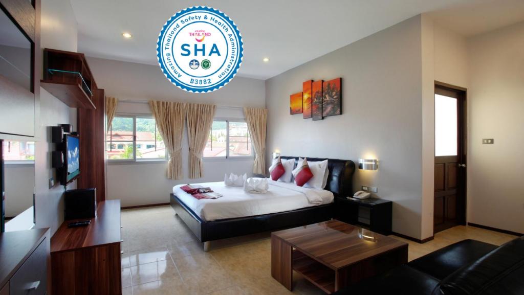 a hotel room with a bed and a living room at U Sabai Living Hotel - SHA Certified in Patong Beach