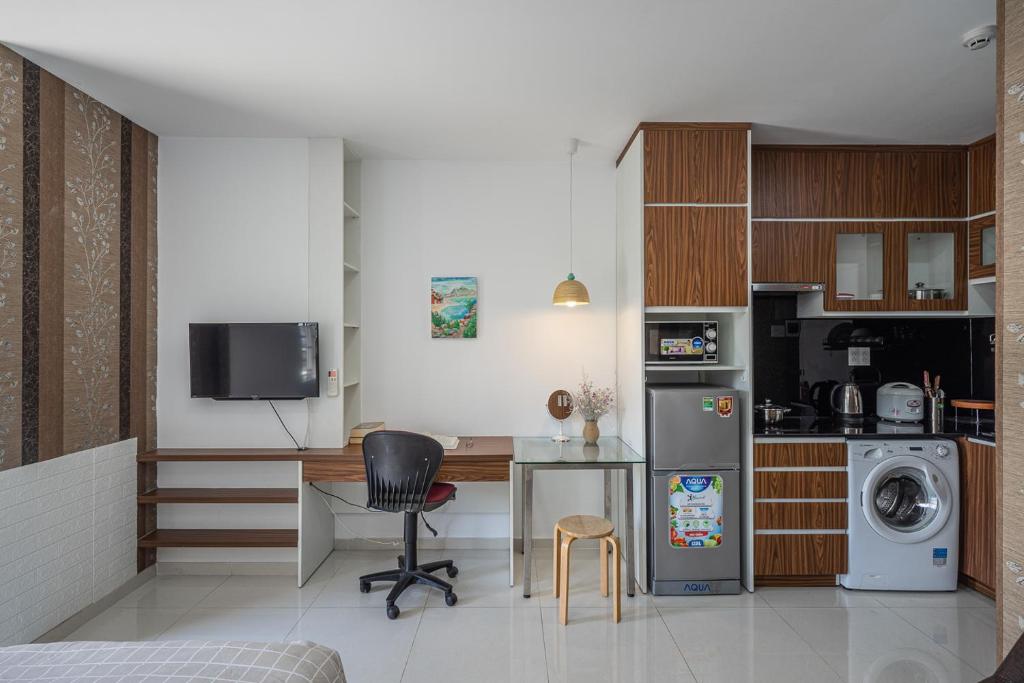 a kitchen with a desk and a table in a room at Green Cocoon in Ho Chi Minh City