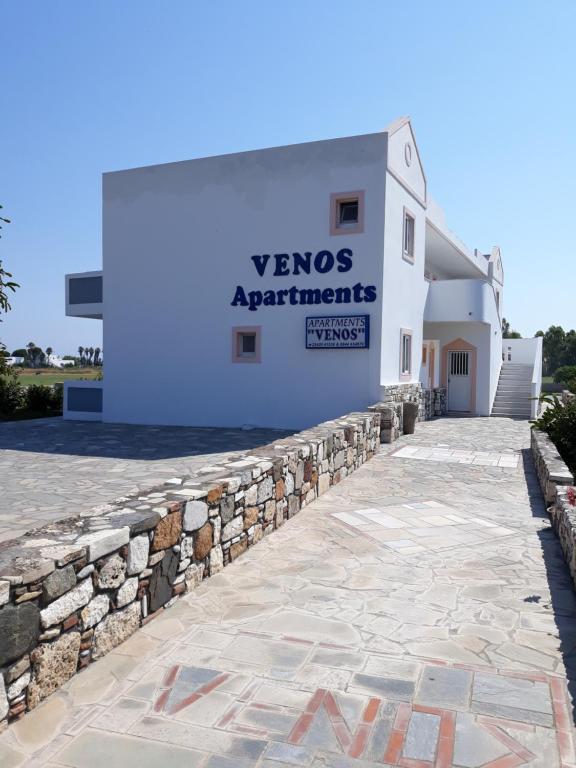 a white building with a sign on it at VENOS APARTMENTS in Marmari
