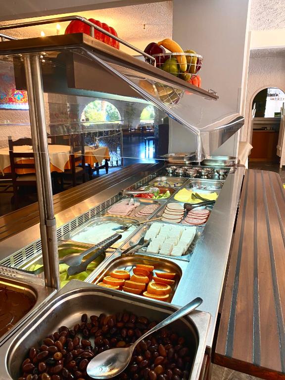 a buffet line with many different types of food at Karteros Hotel in Karteros