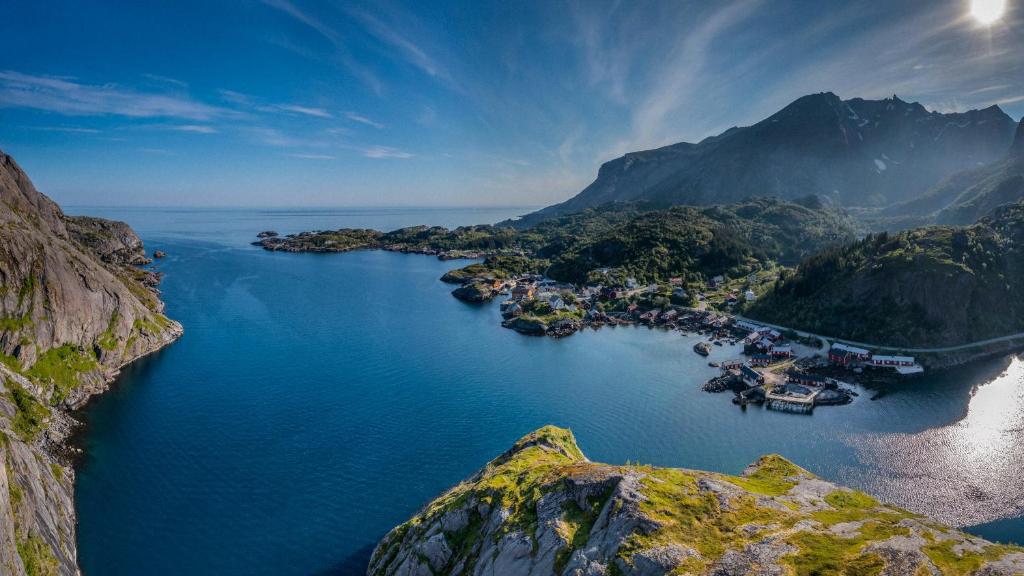 an aerial view of a large body of water with mountains at Lofoten Cottages in Nussfjord